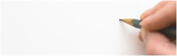 Hand about to write on a blank piece of paper, illustrating you beginning to write your cover letter