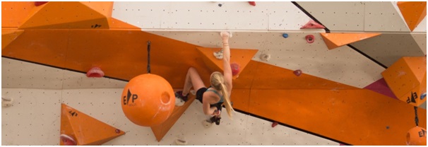 Climber on a very difficult wall, illustrating the skills tested by the PST