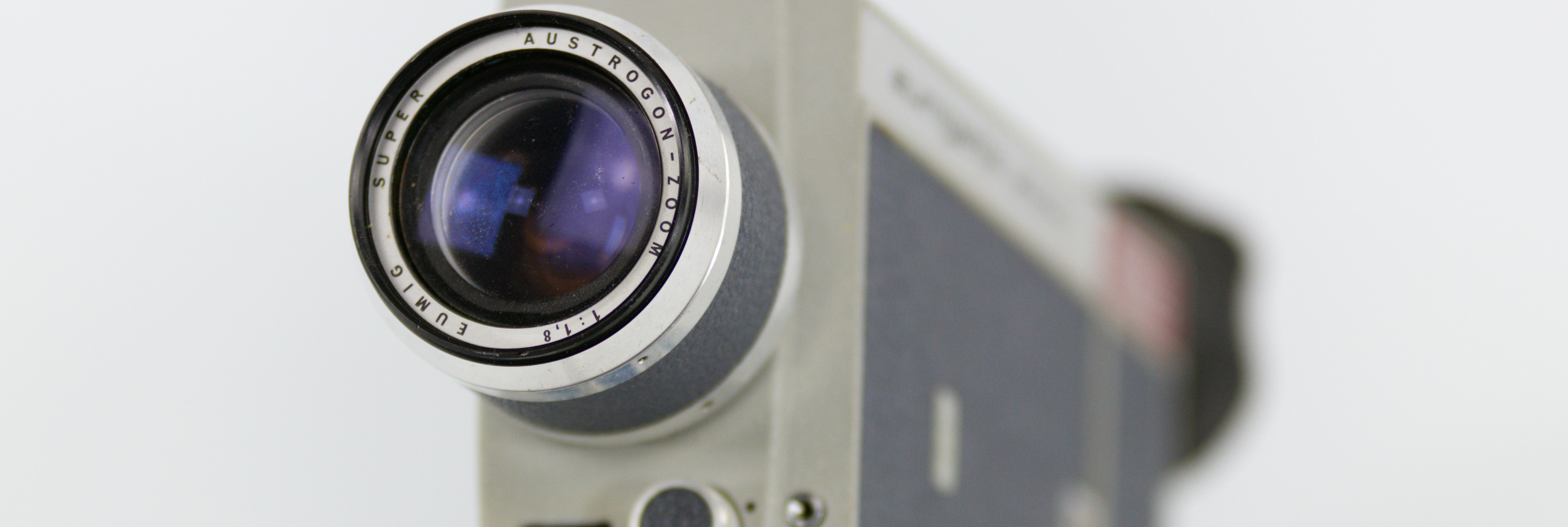 close up of an old fashioned video camera against a white background