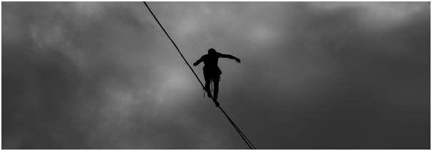 Tightrope walker on a highwire viewed from below