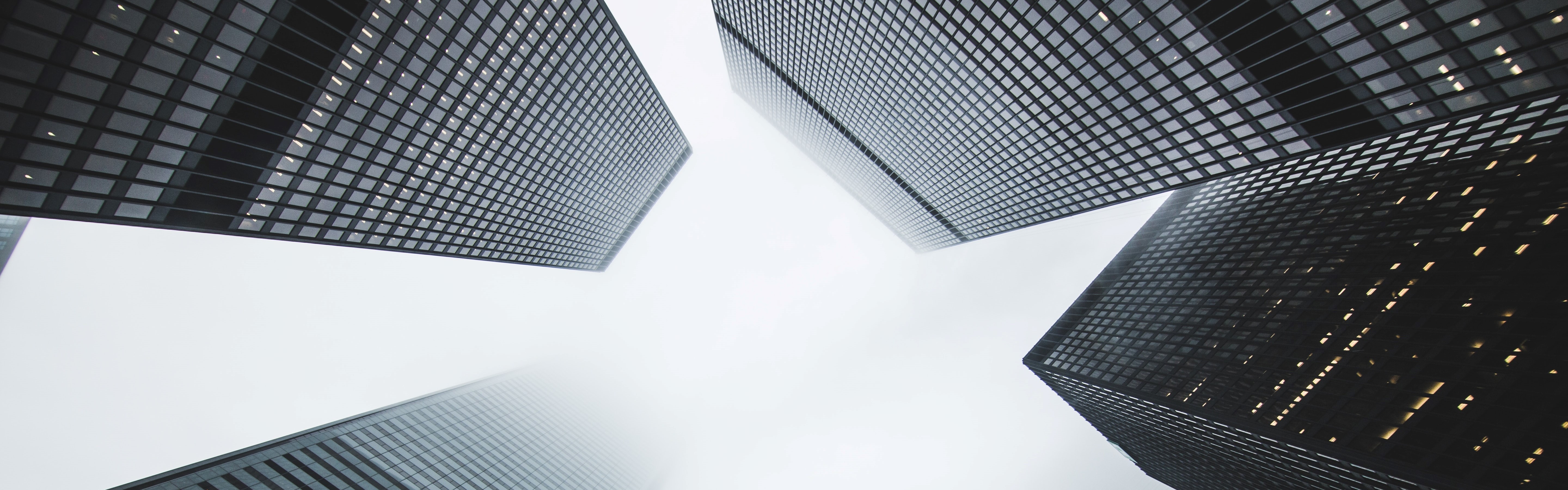 Black skyscrapers viewed looking upwards from street level